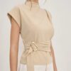 Half-high neck short-sleeve women's top with off-white fabric, waist-cinching design, and button closure